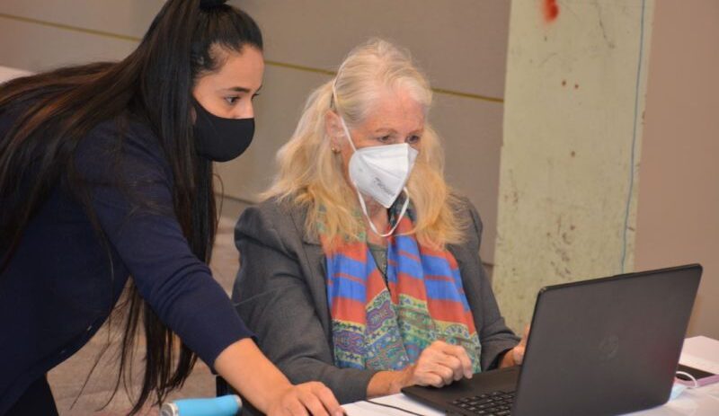 Nuria assists a Computer CORE student with her new laptop.